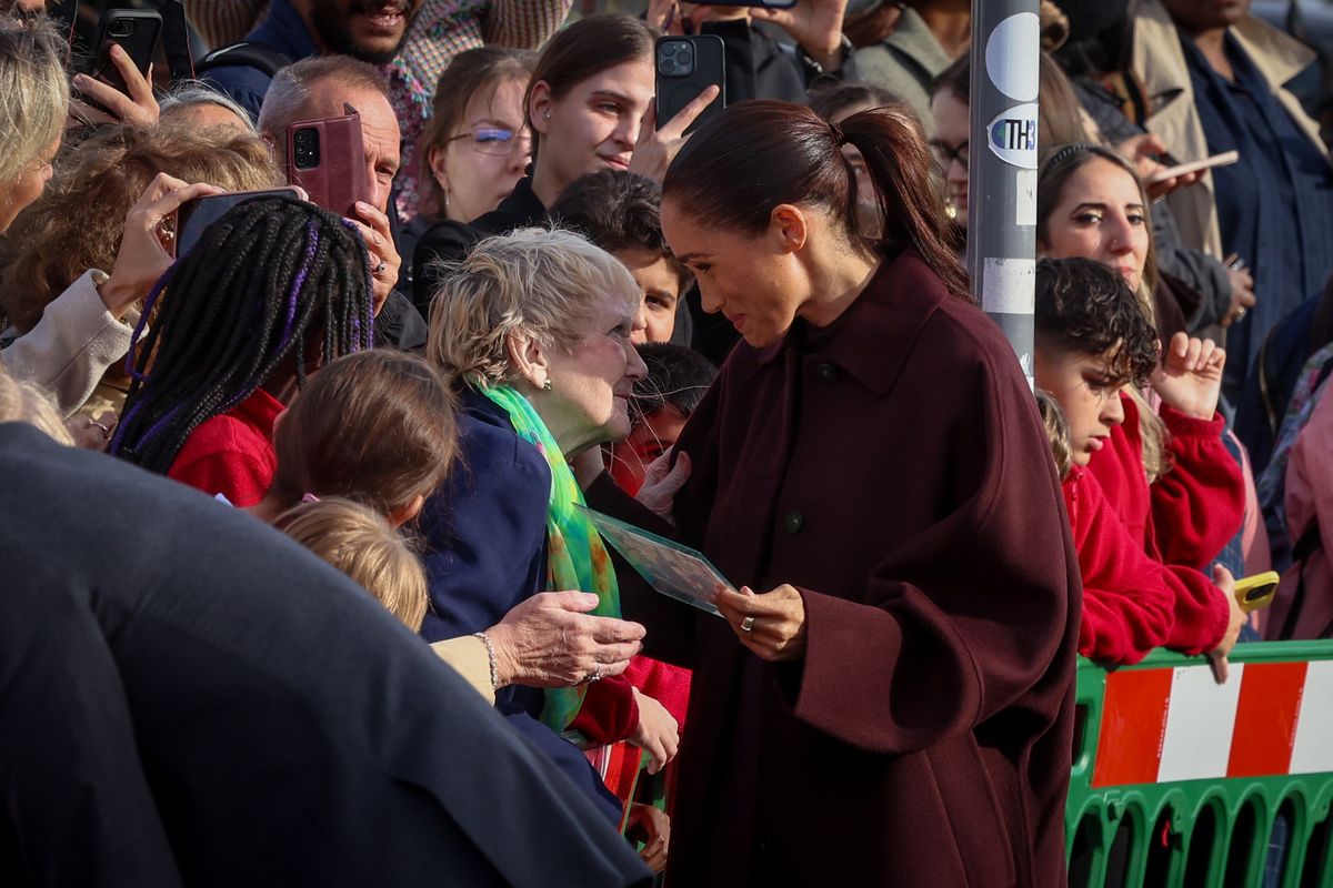 Irene Hardman showing Meghan a framed photo